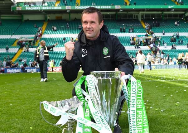 Ronny Deila celebrates with the Premiership trophy at Celtic Park. Picture: SNS