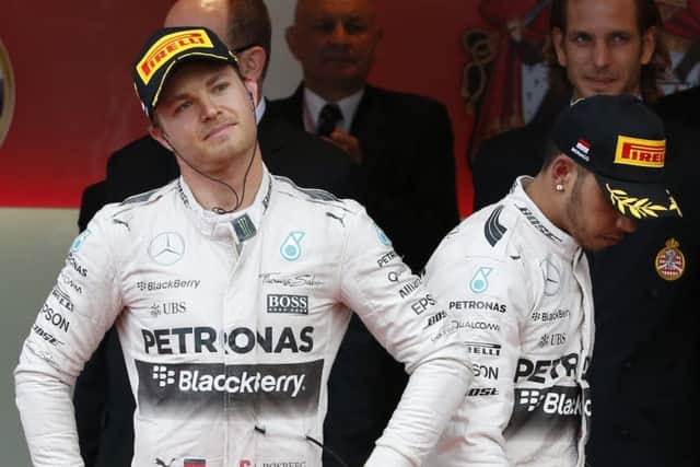Winner Nico Rosberg, left, with a downbeat Lewis Hamilton, right, on the podium. Picture: AP