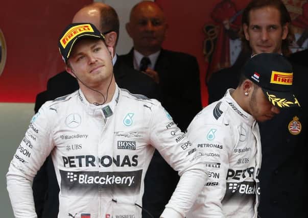 Winner Nico Rosberg, left, with a downbeat Lewis Hamilton, right, on the podium. Picture: AP