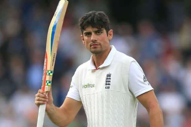 Alastair Cook raises his bat after finishing the day on 153 not out. Picture: PA
