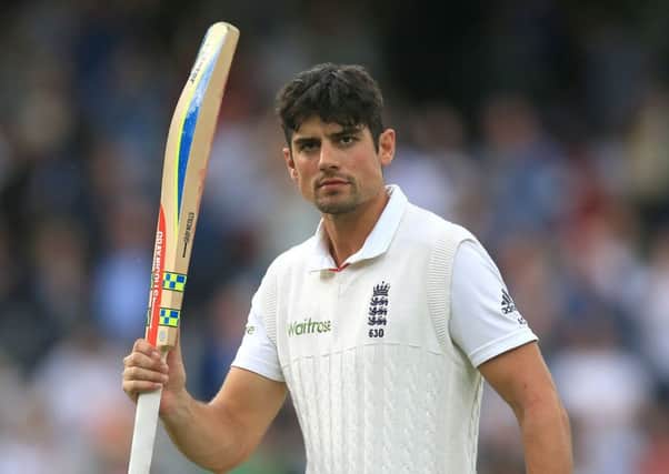 Alastair Cook raises his bat after finishing the day on 153 not out. Picture: PA