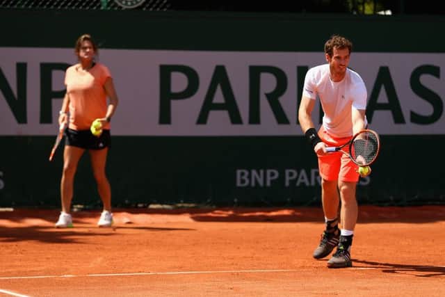Amelie Mauresmo looks on as Andy Murray practices in Paris. Picture: Getty