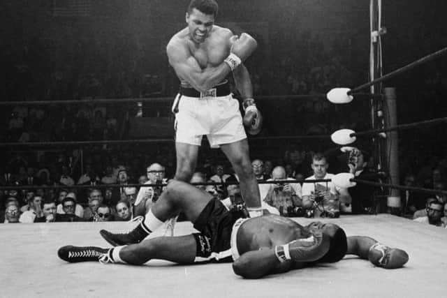 Heavyweight champion Muhammad Ali stands over fallen challenger Sonny Liston. Picture: AP