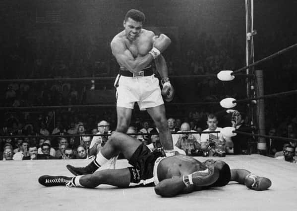 Heavyweight champion Muhammad Ali stands over fallen challenger Sonny Liston. Picture: AP