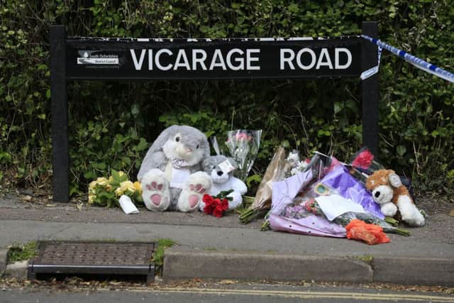 Floral tributes in Vicarage Roade, Didcot, where the bodies were discovered. Picture: PA
