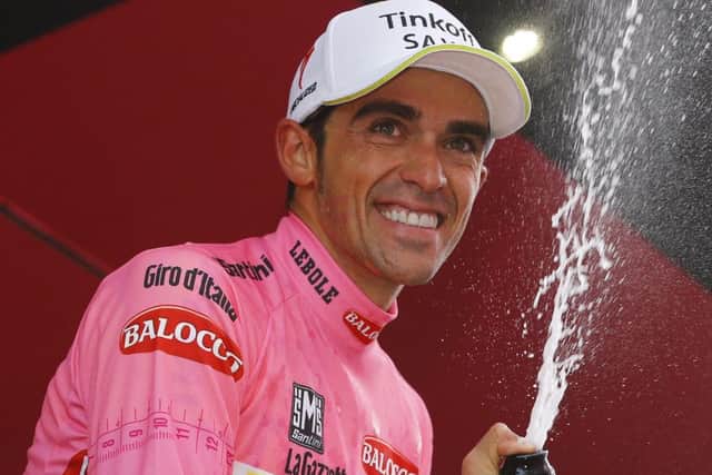 Alberto Contador celebrates on the podium after extending his lead in the Giro. Picture: Luk Benies/AFP/Getty