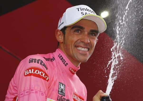 Alberto Contador celebrates on the podium after extending his lead in the Giro. Picture: Luk Benies/AFP/Getty