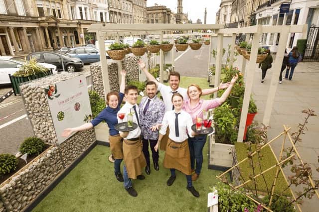 Craig Roman of Dobbie's and staff from Jamie's Bar at one of the capital's two 'parklets'. Picture: Malcolm McCurrach