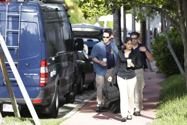 FBI agents retrieve equipment from a van as they prepares to re-enter the offices of the CONCACAF in Florida. Picture: AP