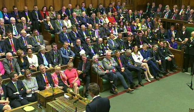 SNP MPs sit in the House of Commons wearing white roses. Picture: PA