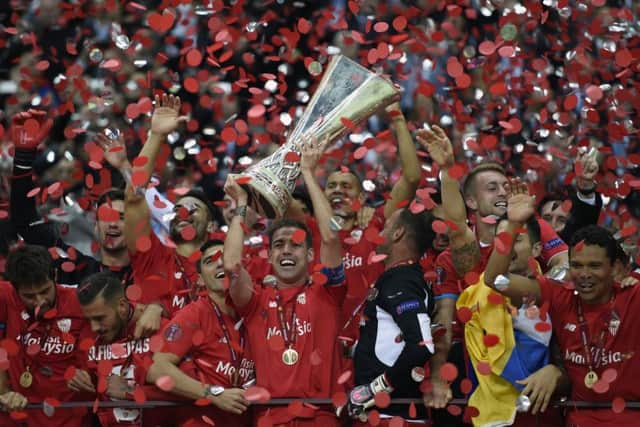 Sevilla players celebrate with the trophy after seeing off Dnipro to claim back-to-back Europa League triumphs. Picture: AFP/Getty