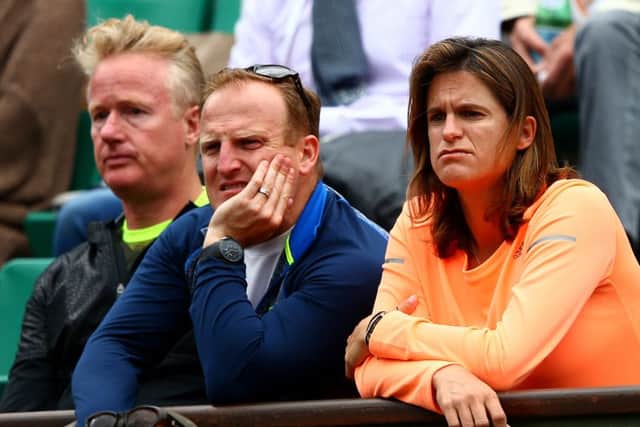 Coach Amelie Mauresmo, trainer Matt Little and physio Mark Bender watch on. Picture: Getty