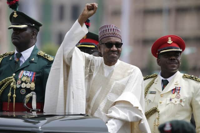Muhammadu Buhari, a bornagain democrat, salutes his supporters during his inauguration. Picture: AP