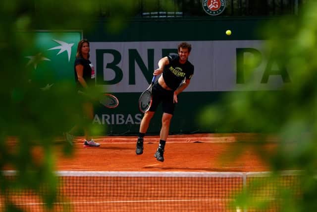 Andy Murray is watched by his coach Amelie Mauresmo at a practice session in Paris yesterday. Picture: Getty