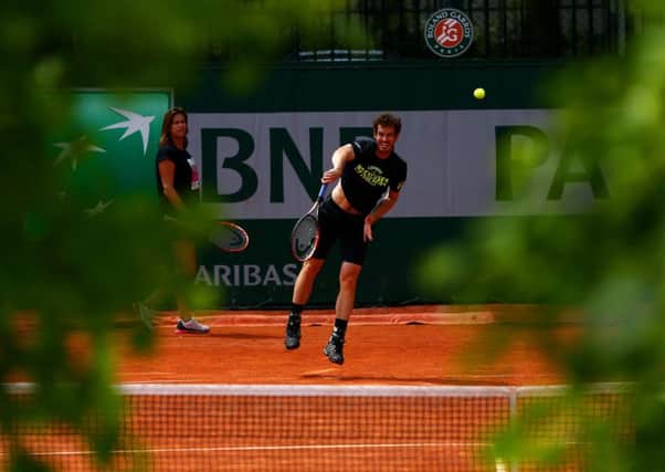 Andy Murray is watched by his coach Amelie Mauresmo at a practice session in Paris yesterday. Picture: Getty