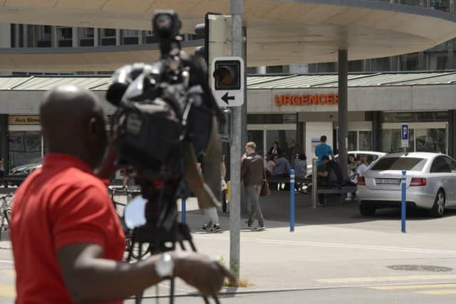 News crews at the Geneva hospital where Kerry was airlifted. Picture: AP