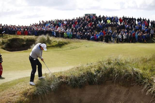 Padraig Harrington plays from the edge of a bunker at the 18th yesterday. Picture: AP
