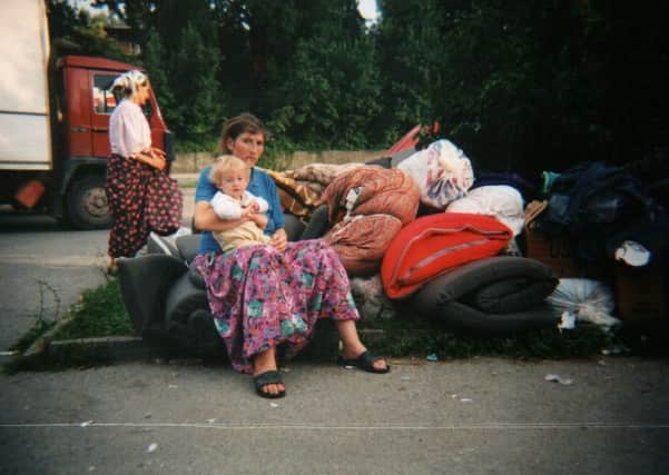 Women and children with their few belongings outside a refugee centre in Tuzla in 1995. Picture: David Hamilton