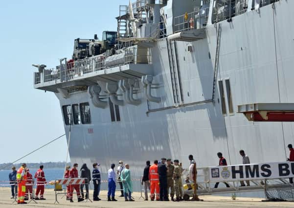 Migrants disembark from the Royal Navys flagship, HMS Bulwark, in the Italian port of Taranto. Picture: AP
