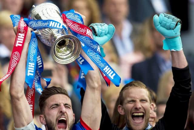 Its the cue for a Highland fling as Inverness captain Graeme Shinnie raises the Scottish Cup following his teams 2-1 victory over Falkirk. Photograph: SNS