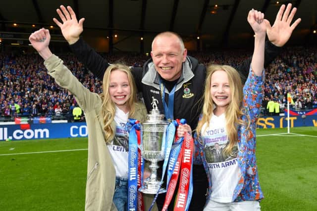 John Hughes celebrates with his daughters. Picture: SNS