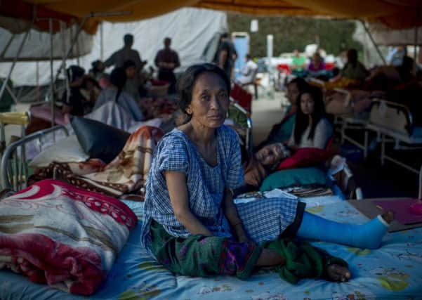 An injured woman sits in a tented hospital in Kathmandu after last months earthquake. Picture: Getty