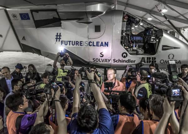 André Borschberg faces a media scrum before taking off on the NanjingtoHawaii leg of Solar Impulse 2s roundtheworld flight. Picture: Getty Images