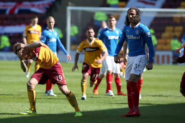 Rangers player Bilel Mohsni and Motherwell's Lee Erwin clash after the Scottish Premiership Play Off Fina. Picture: PA