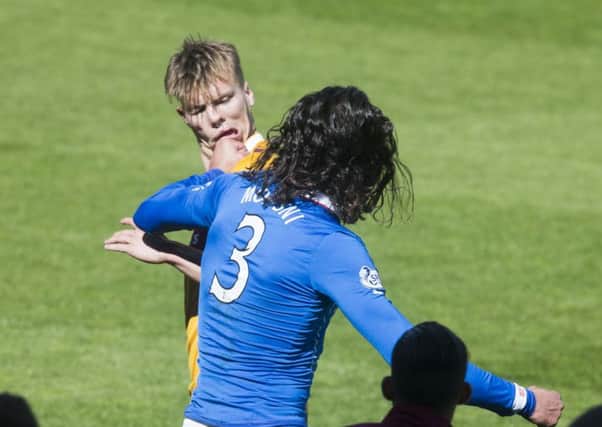 Bilel Mohsni punches Lee Erwin after the final whistle was blown at the end of the game, drawing blood from the strikers face. Picture: Getty