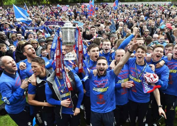 Captain Graeme Shinnie leads his ICT team-mates in a mass celebration with the club's fans. Picture: SNS