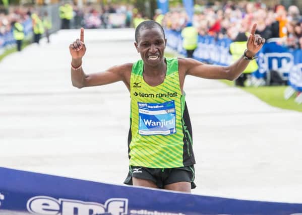 Peter Wanjiru of Kenya reaches the finishing line after fighting the elements to win the Edinburgh Marathon. Picture: Ian Georgeson