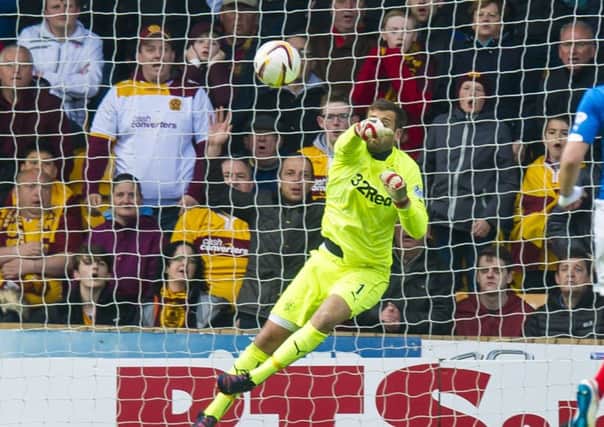 Cammy Bell fails to keep out a shot from Marvin Johnson. Picture: SNS