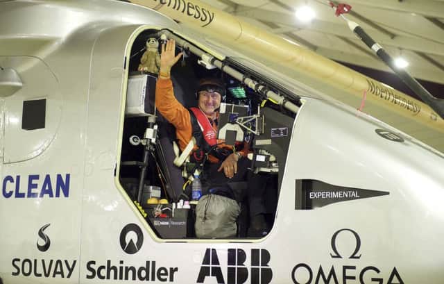 Swiss pilot Andre Borschberg waves from the aircraft Solar Impulse 2 as he leaves China yesterday. Picture: AP