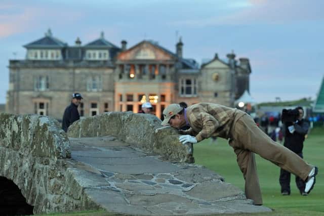 Tom Watson kisses the Swilken Bridge during what he thought would be his last Open at St Andrews. Picture: Ian Rutherford