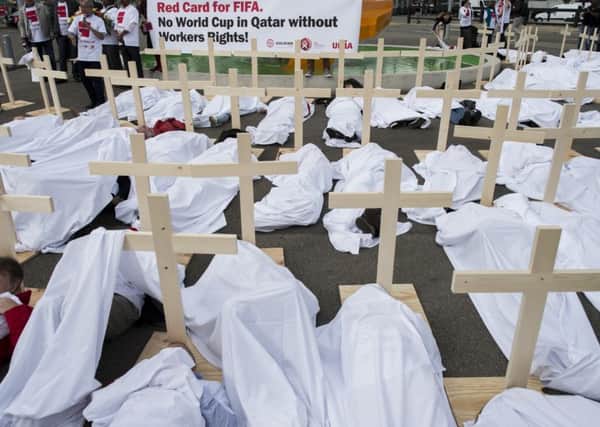 Activists set up wooden crosses during a protest against alleged Qatari breaches of human rights in front of the Hallenstadion in Zurich, Switzerland. Picture: AP