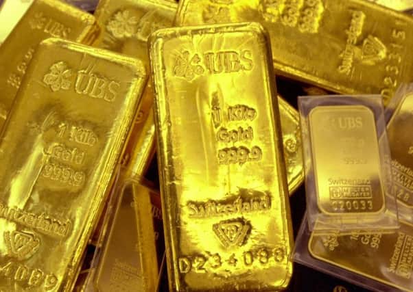Gold has been considered a good bet compared to other investments but even its value has fluctuated amid economic storms. Picture: AFP/Getty