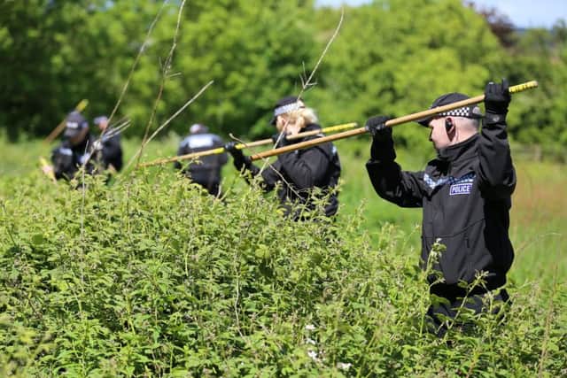Officers search scrubland close to the home of Amber. Picture: Tom Maddick/Ross Parry/SWNS