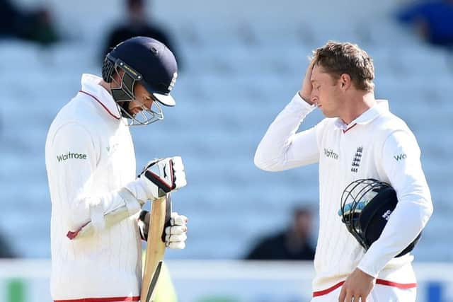 Englands James Anderson, left, and Jos Buttler stand dejected after losing the second Test. Picture: PA