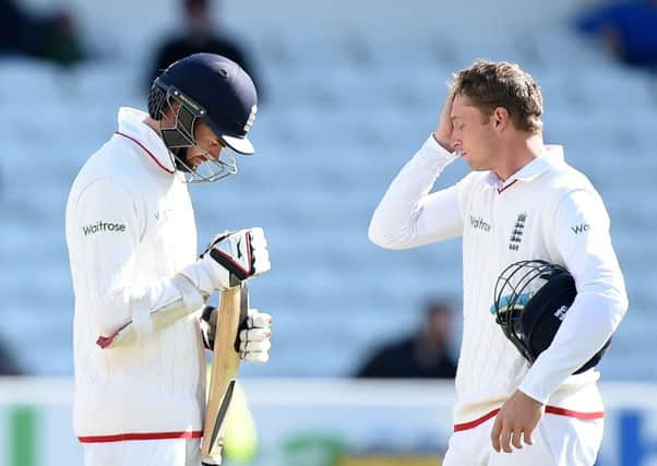 Englands James Anderson, left, and Jos Buttler stand dejected after losing the second Test. Picture: PA