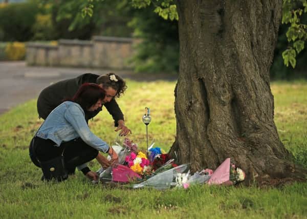 Locals lay flowers near to where the body was discovered. Picture: Getty