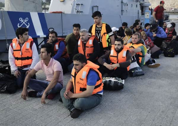 Migrants from Syria wait at the port of Kos island, Greece, on Tuesday, June 2, 2015, after they were rescued by the Greek Coast Guard. Picture: AP