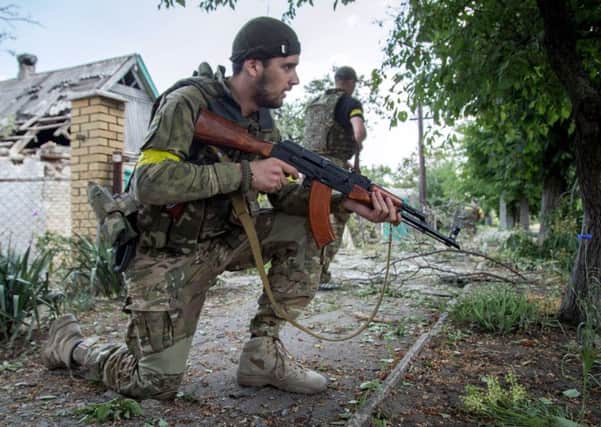 Ukrainian servicemen on patrol in the Ukrainian city of Maryinka Picture: AFP/Getty