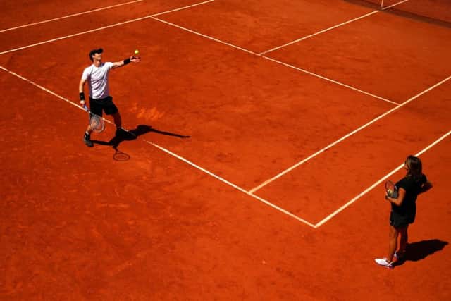 Andy Murray warms up for todays French Open semi-final under the watchful eye of Amelie Mauresmo. Picture: Getty Images