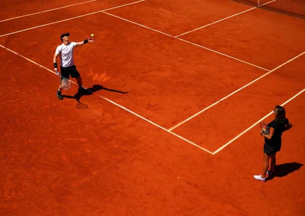 Andy Murray warms up for todays French Open semi-final under the watchful eye of Amelie Mauresmo. Picture: Getty Images