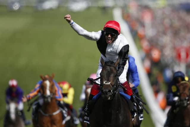Frankie Dettori whoops with delight as he rides Golden Horn to victory in The Investec Derby at Epsom yesterday. Photo: Alan Crowhurst/Getty