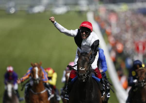 Frankie Dettori whoops with delight as he rides Golden Horn to victory in The Investec Derby at Epsom yesterday. Photo: Alan Crowhurst/Getty
