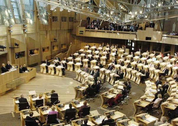 MSPs sit in the debating chamber at Holryood. Picture: PA
