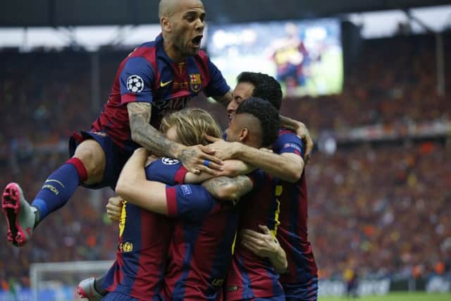 Barcelona Dani Alves, top, celebrates after Ivan Rakitic scored his side's first goal during the Champions League final. Picture: AP