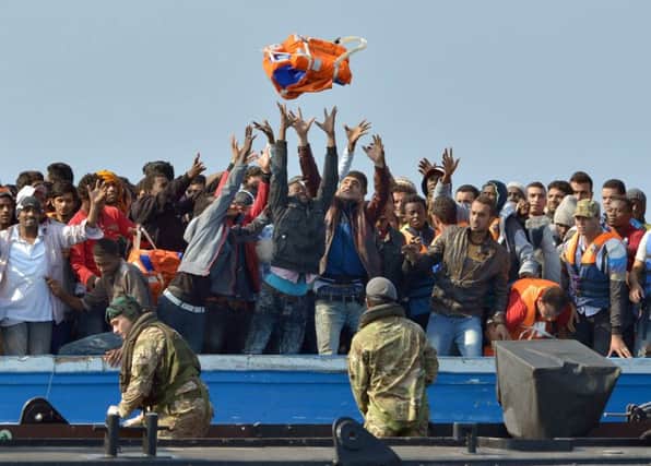 Royal Marines from HMS Bulwark help rescue migrants stranded off the Libyan coast, before taking them to the Royal Navy ship Picture: Rowan Griffiths/Daily Mirror/PA Wire