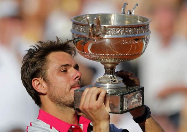 Switzerland's Stan Wawrinka lifts the cup after defeating Serbia's Novak Djokovic. Picture: AP